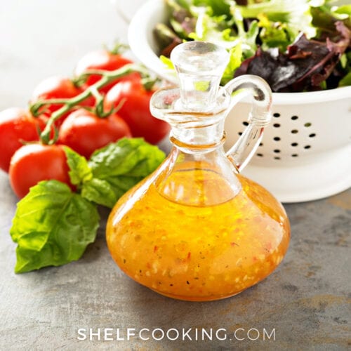 Homemade vinaigrette and salad on a counter, from Shelf Cooking