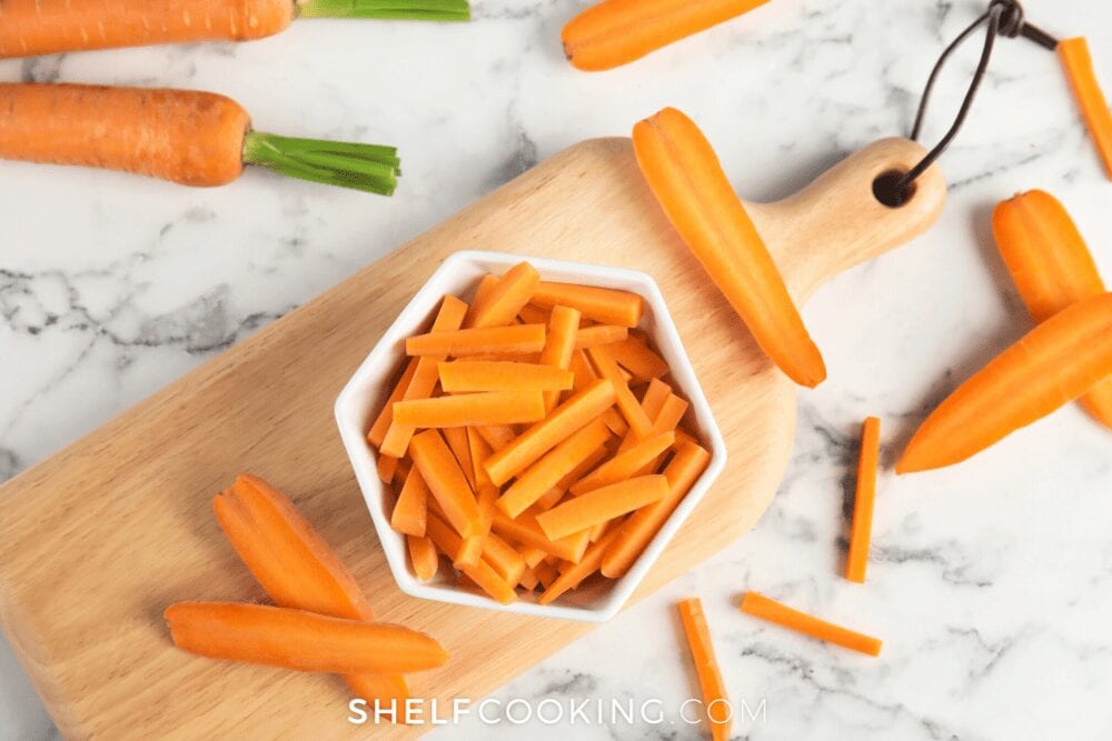 Cut carrots in a bowl on a cutting board, from Shelf Cooking
