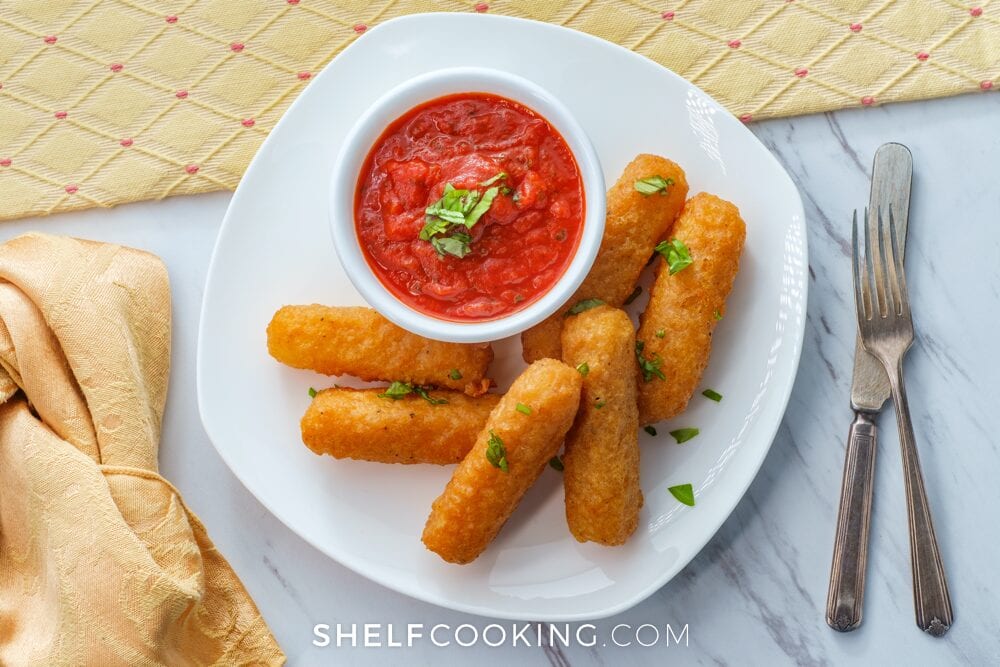 Mozzarella sticks and pizza sauce on a plate, from Shelf Cooking