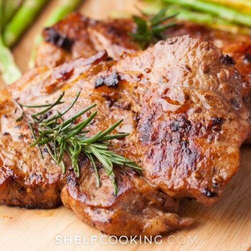 Cooked pork chops on a cutting board, from Shelf Cooking
