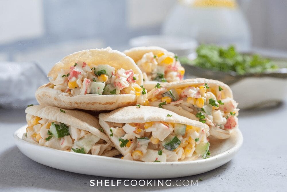 pitas filled with crab salad on a white plate, from Shelf Cooking