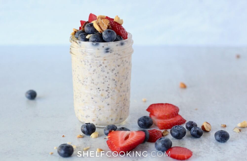 overnight oats with fruit topping on a countertop from Shelf Cooking 