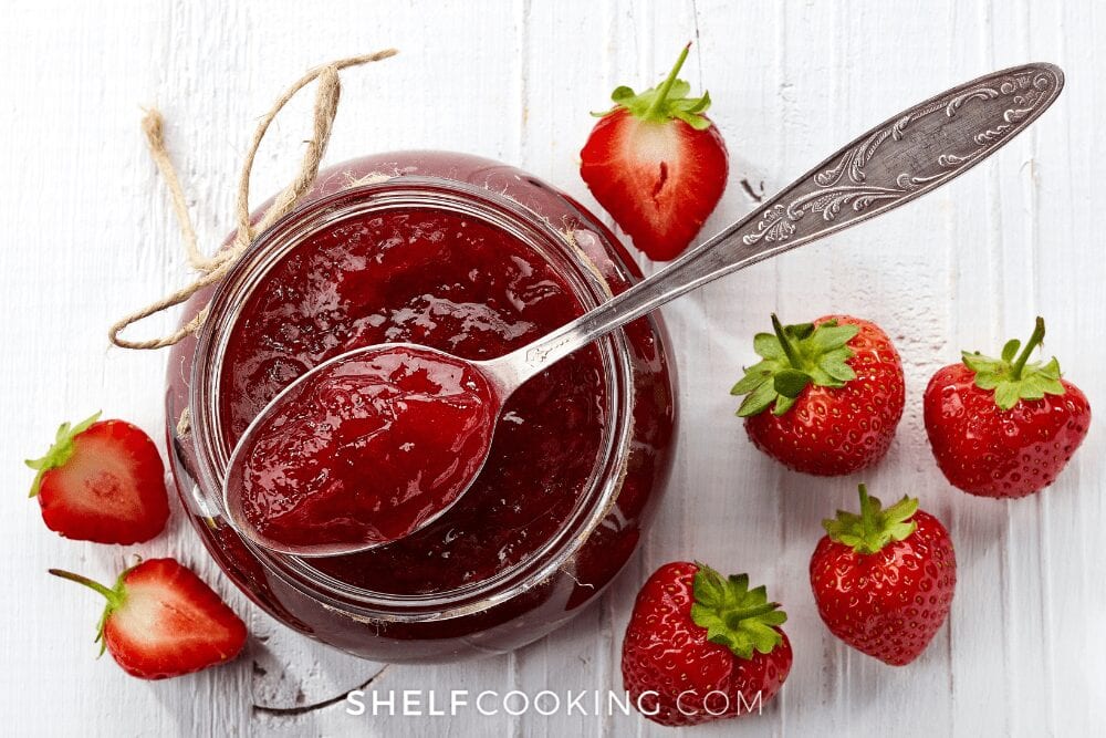 glass jar of strawberry jam with spoon, from Shelf Cooking