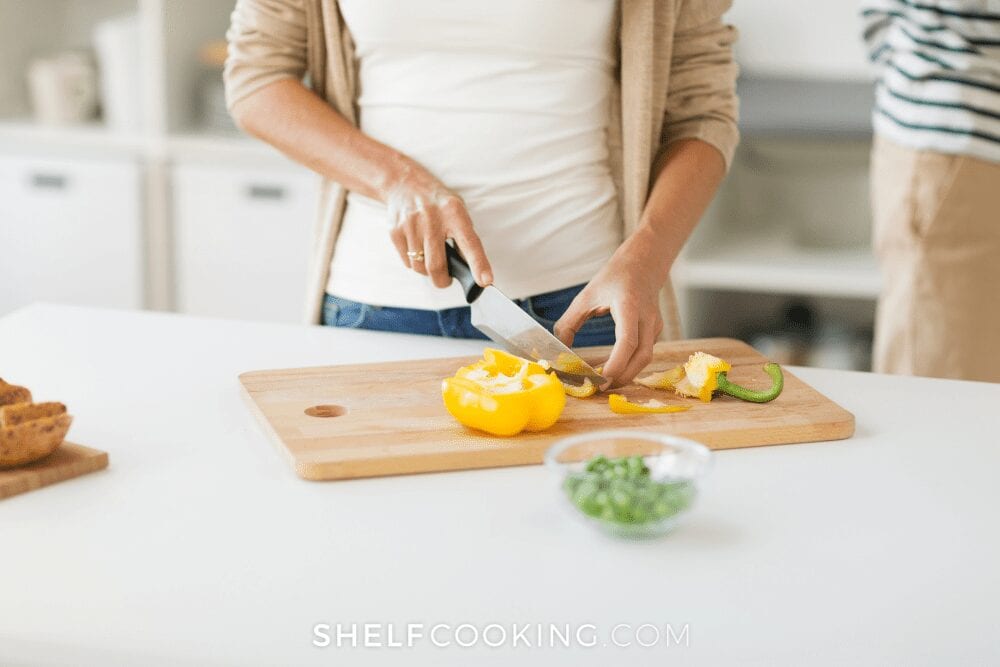 chopping veggies to hide in food, from Shelf Cooking