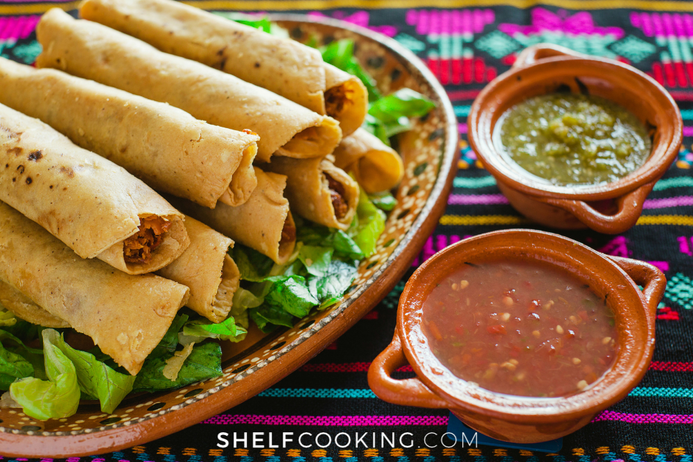 Chicken taquitos on a plate from Shelf Cooking. 
