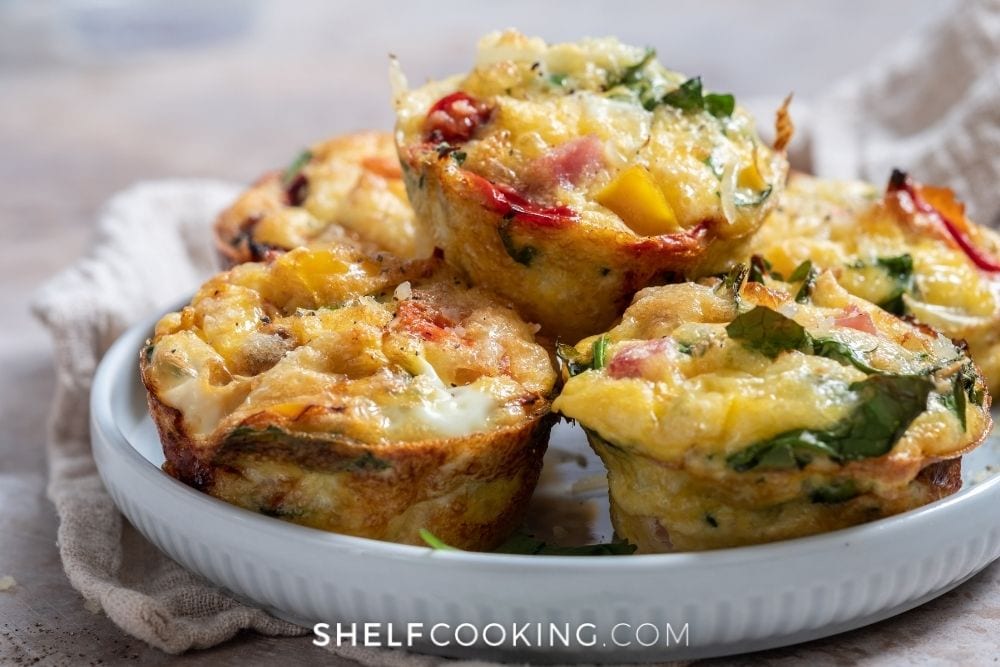 Egg muffins in a white dish for egg recipes from Shelf Cooking. 