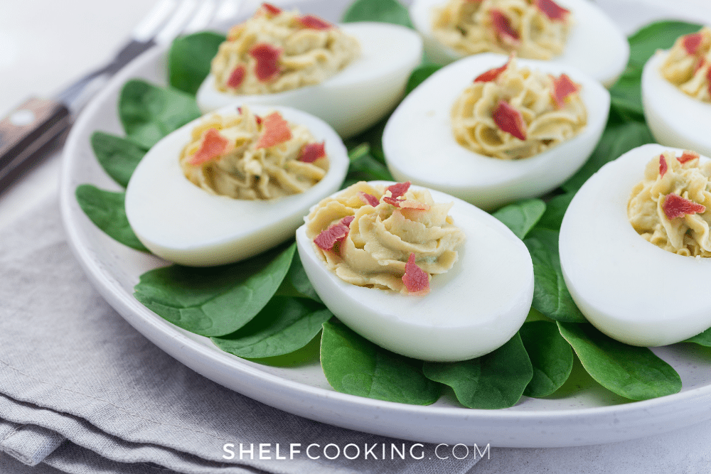 avocado deviled eggs over spinach, from Shelf Cooking
