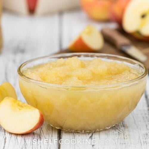 Homemade applesauce in a glass bowl from Shelf Cooking.