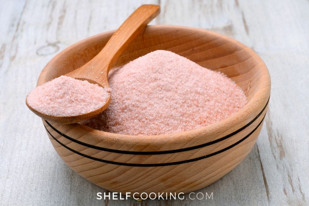 Pink Himalayan salt in a wooden bowl from Shelf Cooking. 