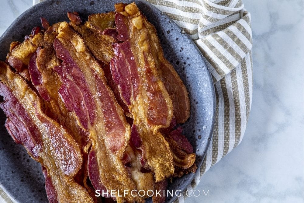 Cooked bacon on a plate from Shelf Cooking. 