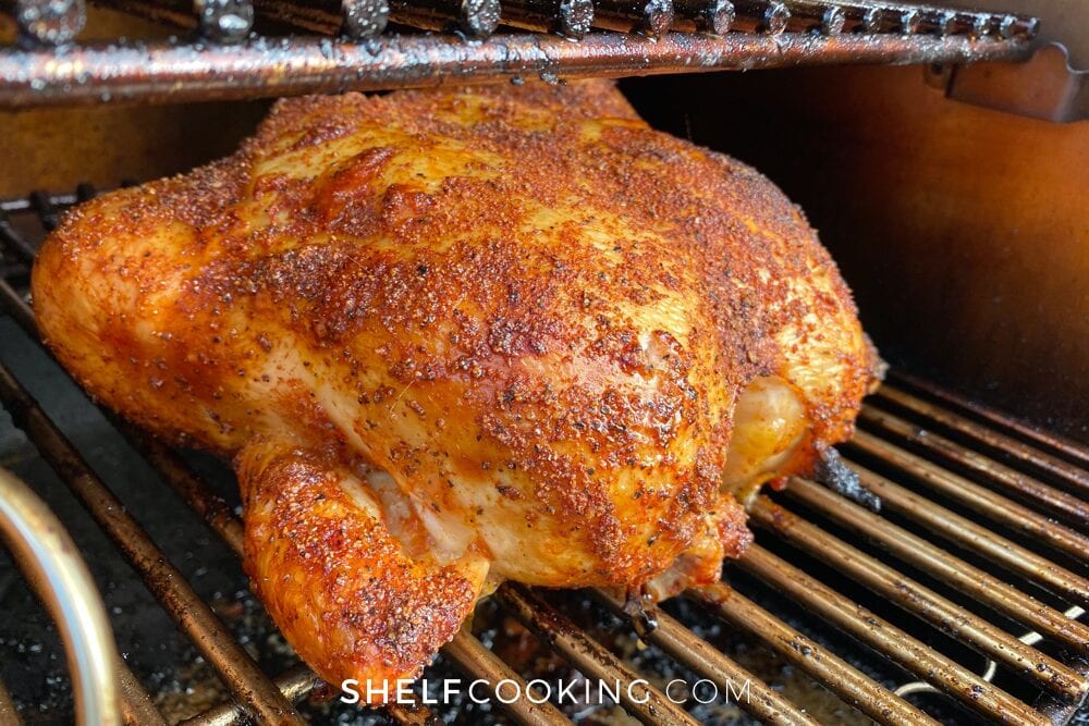 Whole chicken in a smoker from Shelf Cooking. 