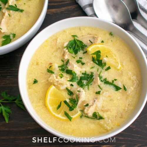 Greek lemon chicken soup in a bowl from Shelf Cooking.
