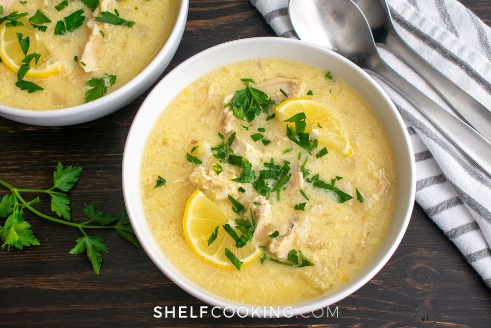 Greek lemon chicken soup in a bowl from Shelf Cooking. 