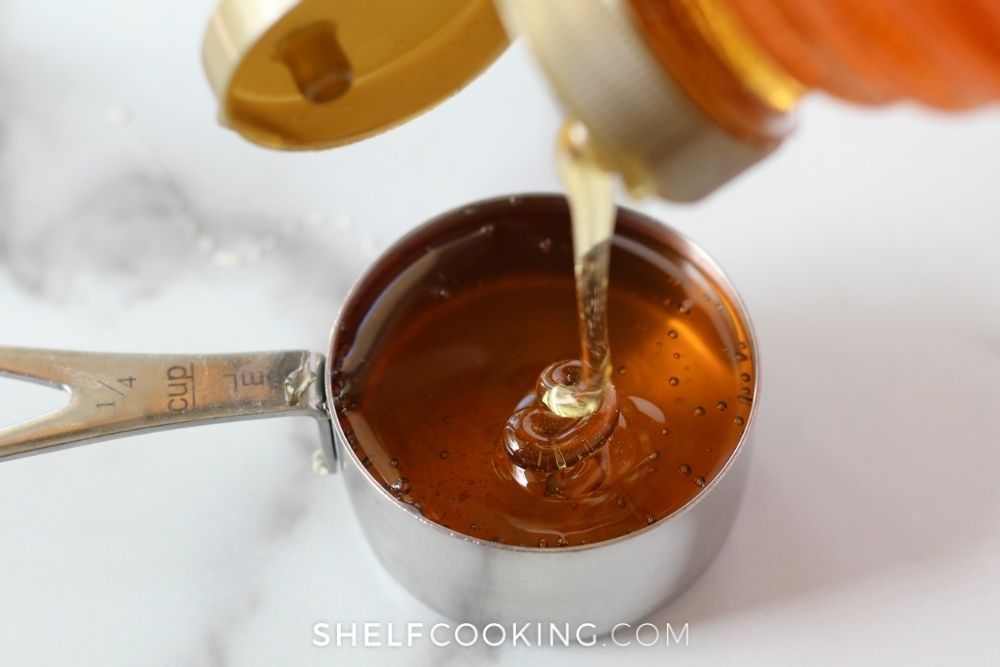 Honey in a measuring cup from Shelf Cooking. 