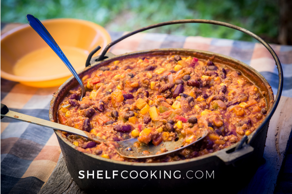 Image of Dutch oven pot with chili con carne. -Shelf Cooking