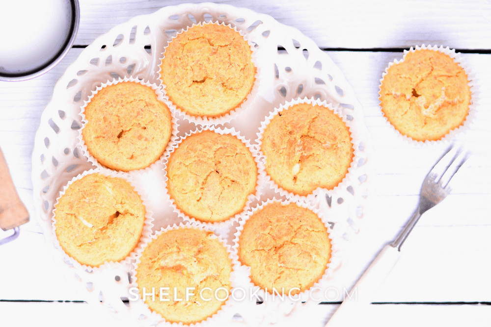 Overhead image of cornbread muffins on a white plate. - Shelf Cooking