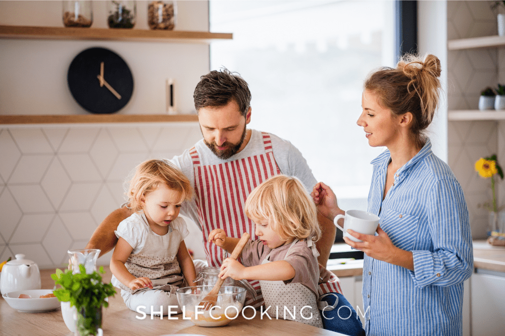 Image of a mother and father cooking with two young children in their kitchen. - Shelf Cooking
