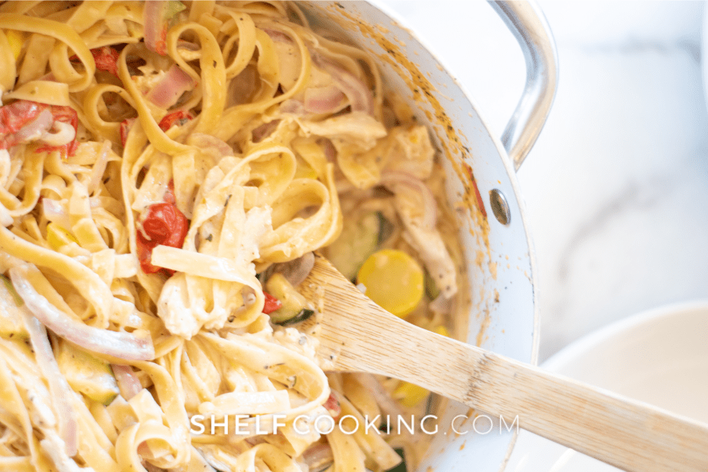 Image of a pasta dish with vegetables and cream sauce. - Shelf Cooking